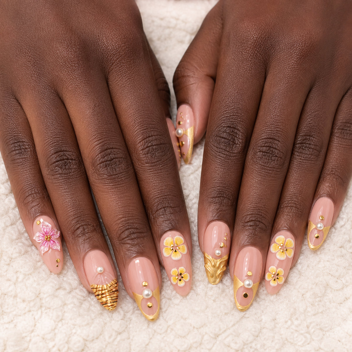 Gilded Hibiscus press-on nails shown on dark-skinned two hands