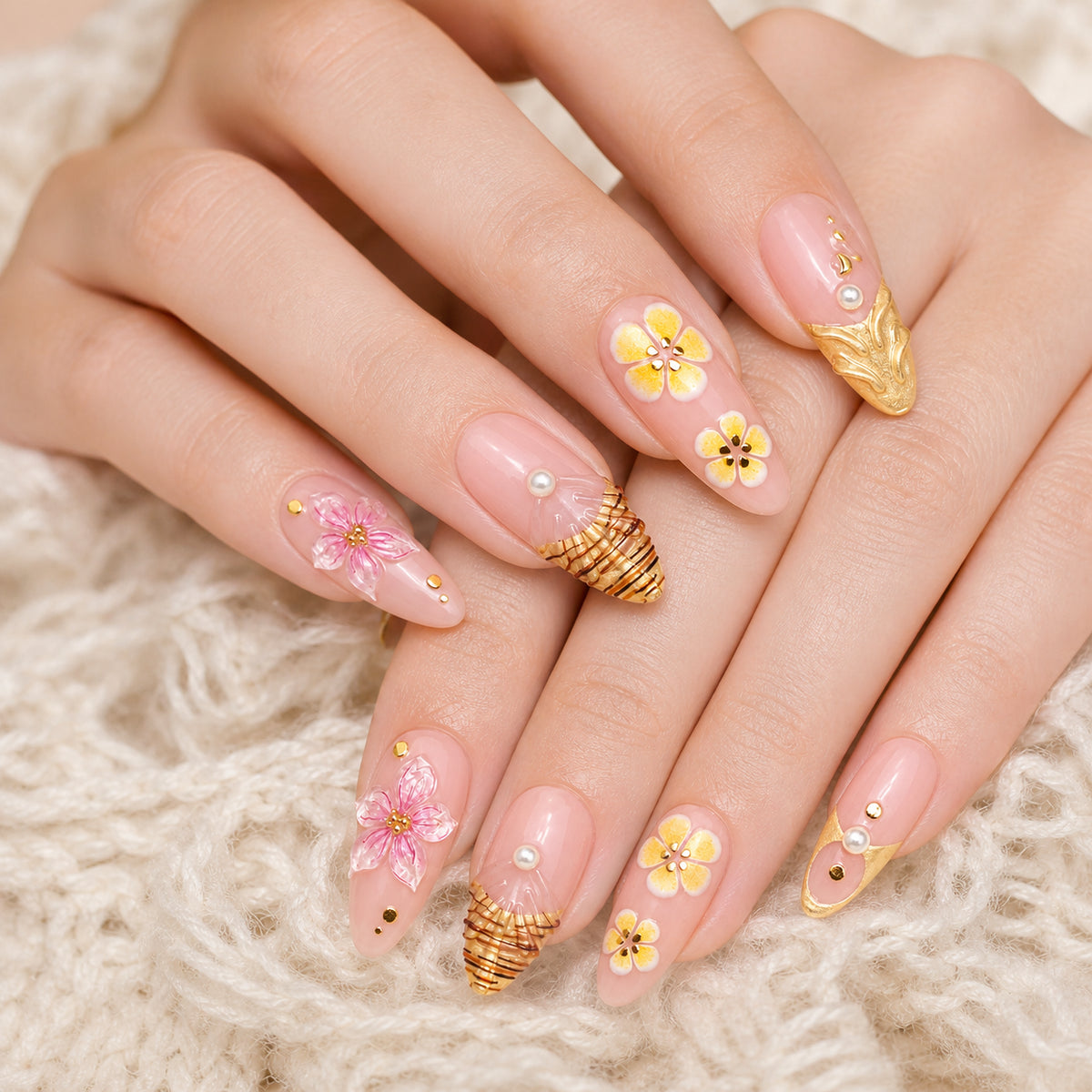 Gilded Hibiscus press-on nails shown on light-skinned two hands