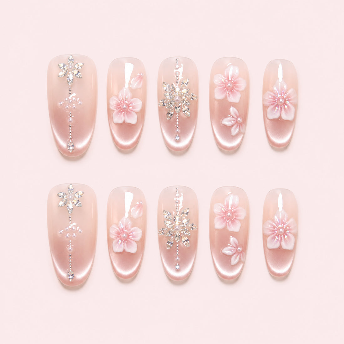 Petal Chandelier is a handmade satin pearl medium oval press-on nail set in pink, white, silver, featuring layered flowers and rhinestone botanical details, flat lay