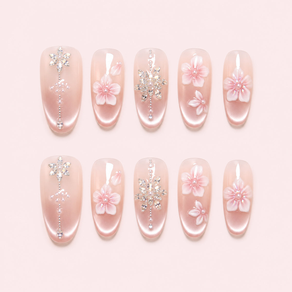 Petal Chandelier is a handmade satin pearl medium oval press-on nail set in pink, white, silver, featuring layered flowers and rhinestone botanical details, flat lay