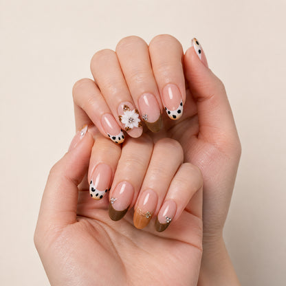 Spotted Magnolia press-on nails shown on light-skinned two hands