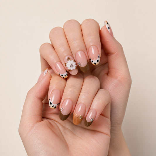 Spotted Magnolia press-on nails shown on light-skinned two hands