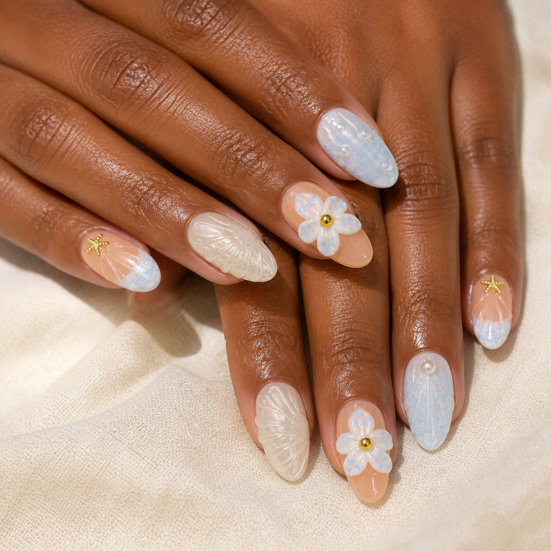 Tidal Picnic press-on nails shown on dark-skinned two hands