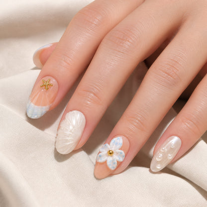 Tidal Picnic press-on nails shown on light-skinned one hand