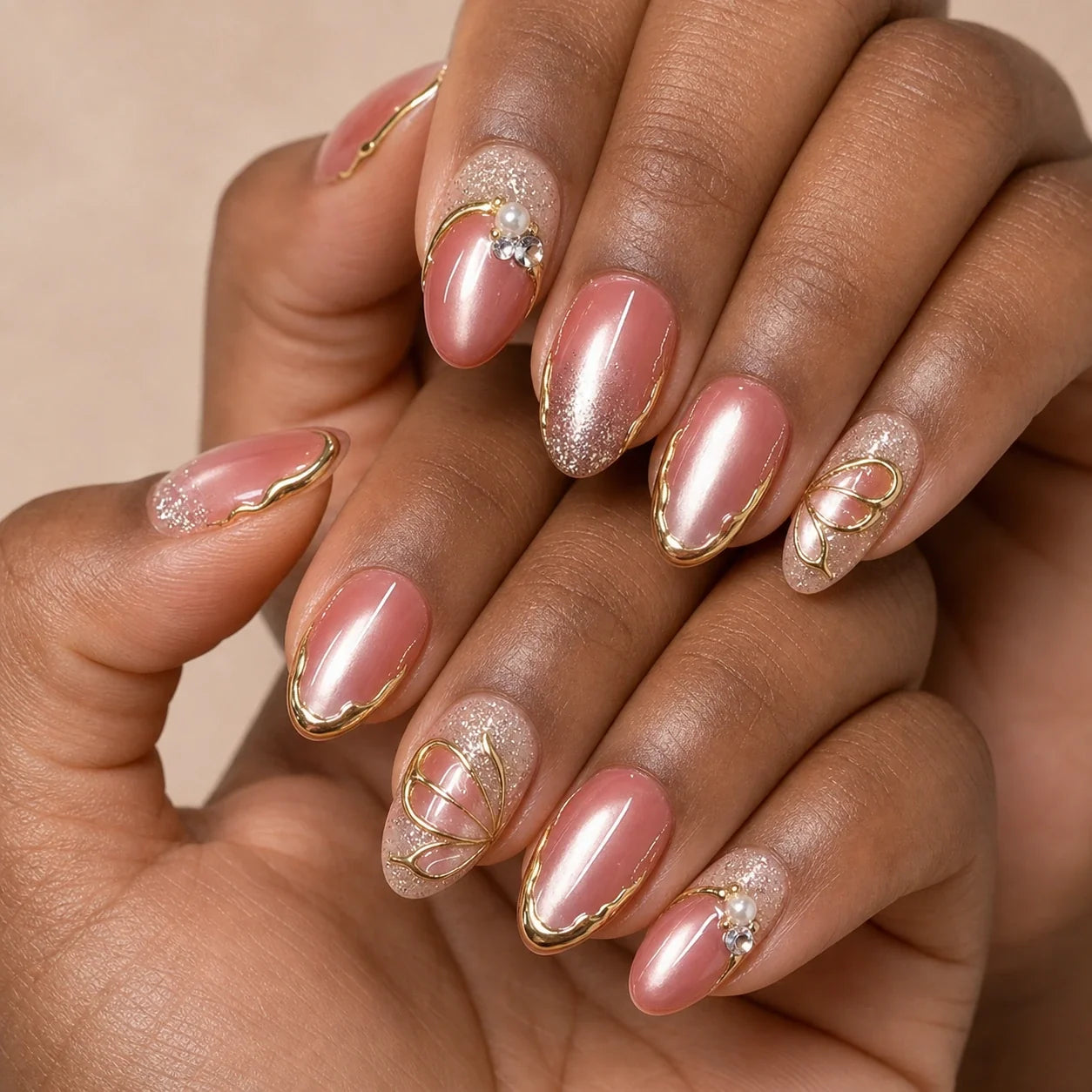 Mauve Monarch dusty rose cat-eye medium almond press-on nails on two medium-brown hands