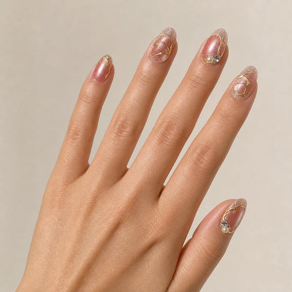 Mauve Monarch dusty rose cat-eye medium almond press-on nails on one open hand
