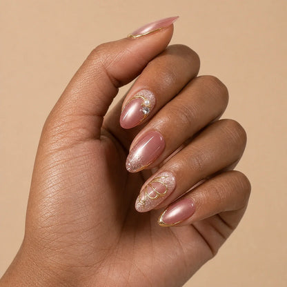 Mauve Monarch dusty rose cat-eye medium almond press-on nails on one medium-brown hand