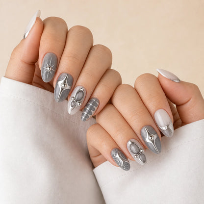 Mercury Reliquary silver grey medium almond press-on nails on two softly curled hands