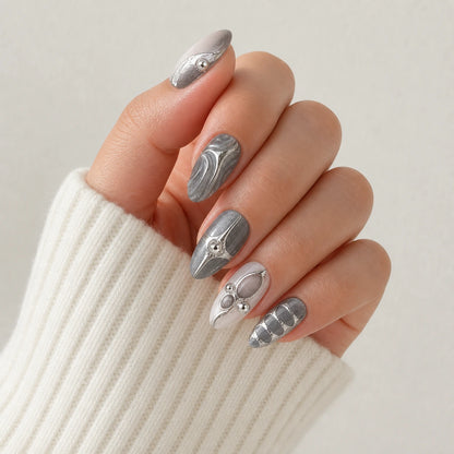 Mercury Reliquary silver grey medium almond press-on nails on one softly curled hand