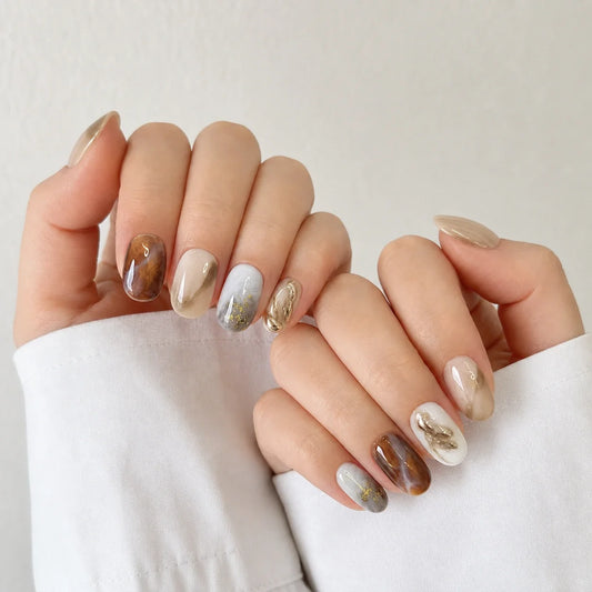 Molten Mocha manicure on two softly curled hands