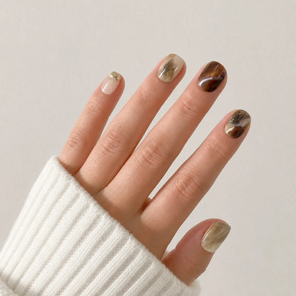 Molten Mocha coffee marble nails on one open hand