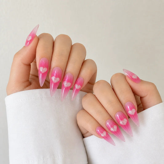 Neon Heartbeat fluorescent pink heart manicure on two softly curled hands