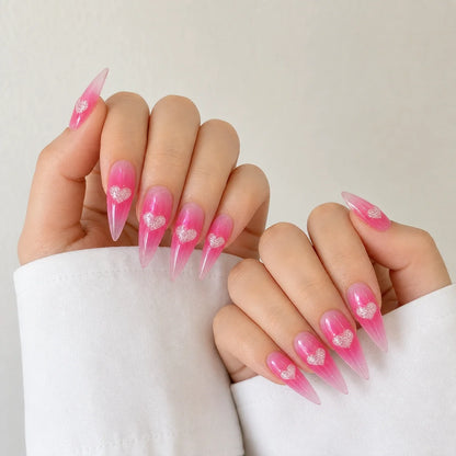 Neon Heartbeat fluorescent pink heart manicure on two softly curled hands