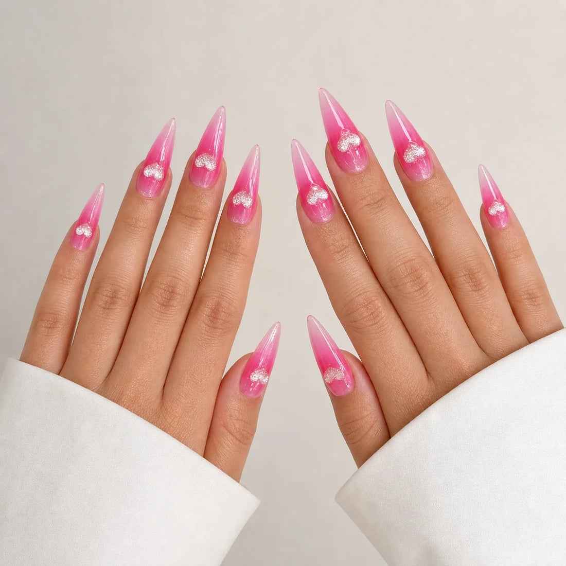 Neon Heartbeat long stiletto heart press-on nails on two open hands