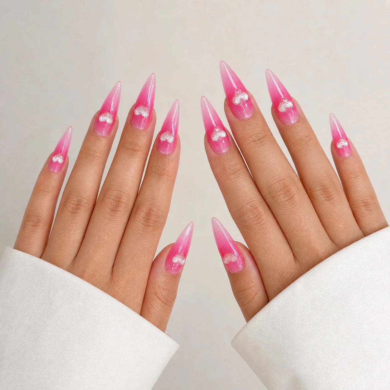 Neon Heartbeat long stiletto heart press-on nails on two open hands