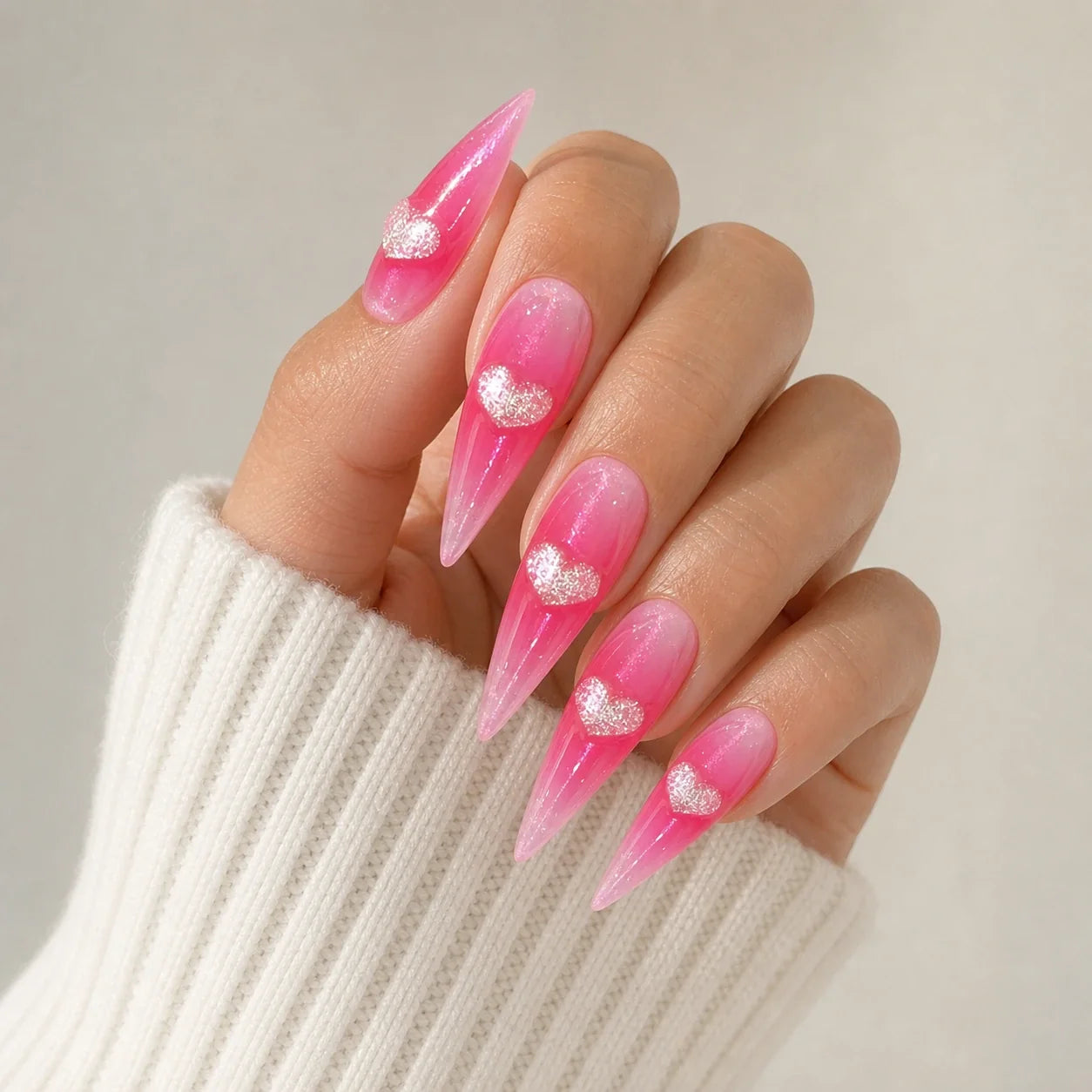 Neon Heartbeat silver-heart press-on manicure on one softly curled hand