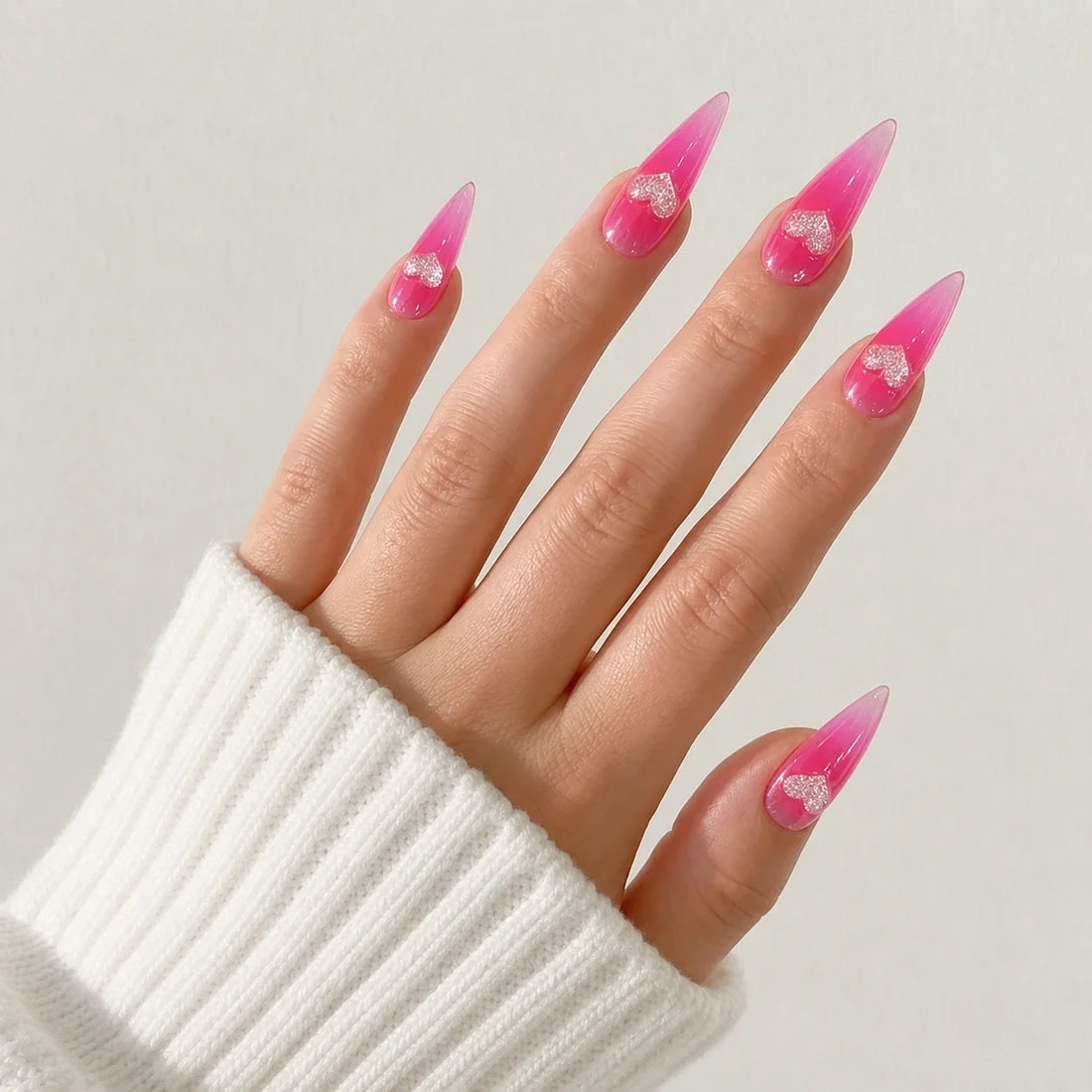 Neon Heartbeat fluorescent pink stiletto nails on one open hand