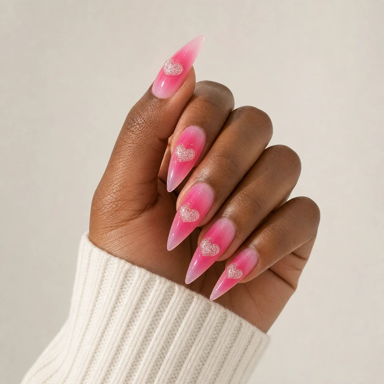 Neon Heartbeat pink jelly heart manicure on one medium-brown hand