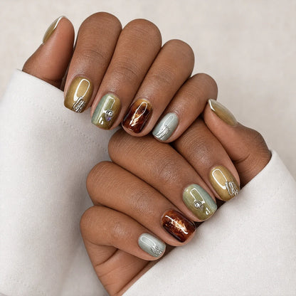 Patina Relic olive cat-eye nails on two medium-brown hands