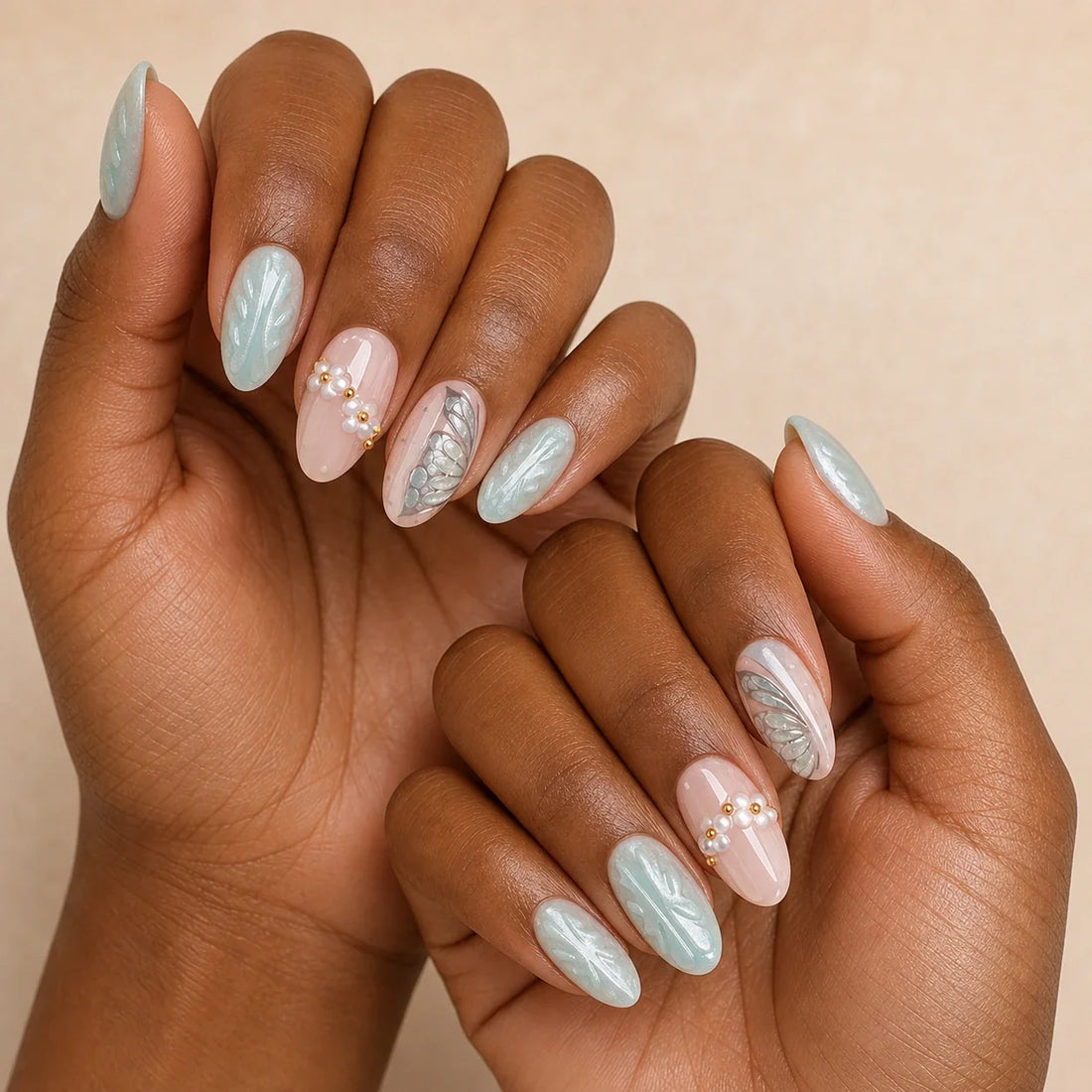 Pearlwing Garden seafoam medium almond press-on nails on two medium-brown hands