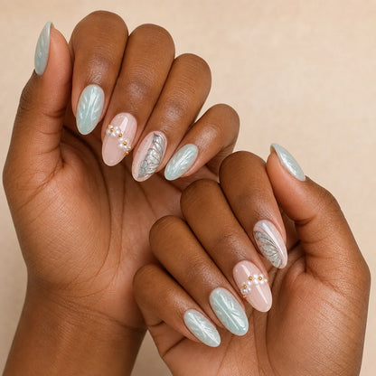 Pearlwing Garden seafoam medium almond press-on nails on two medium-brown hands