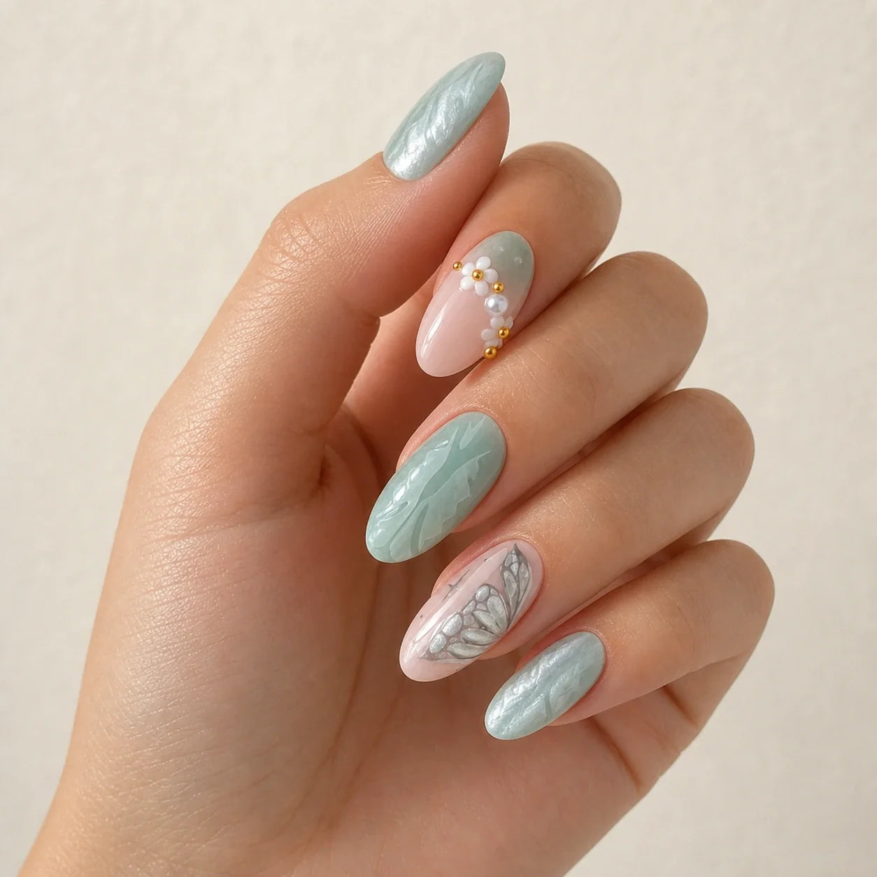 Pearlwing Garden seafoam medium almond press-on nails on one softly curled hand