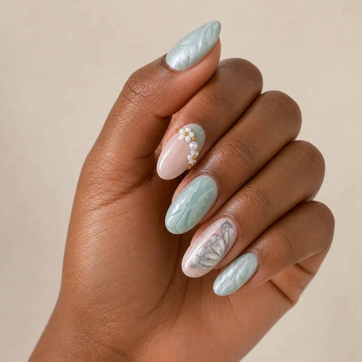 Pearlwing Garden seafoam medium almond press-on nails on one medium-brown hand