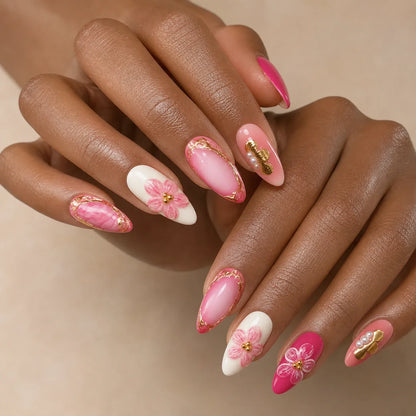 Petal Regalia gold floral nails on two medium-brown hands