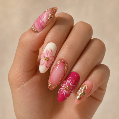 Petal Regalia pink marble press-on manicure on one curled hand