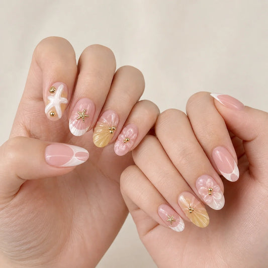 Pink Sand Souvenir coastal manicure on two softly curled hands