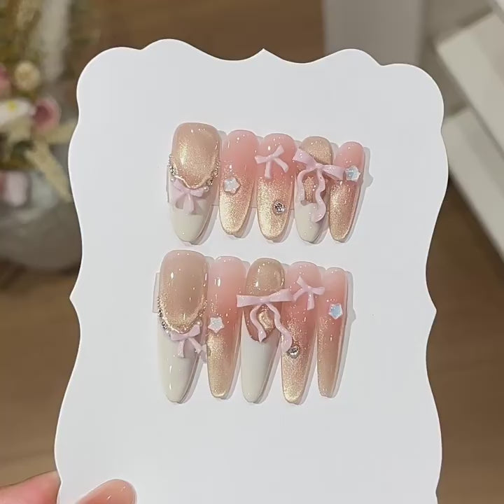 Ribbon Constellation product video showing blush shimmer press-on nails with bows and stars