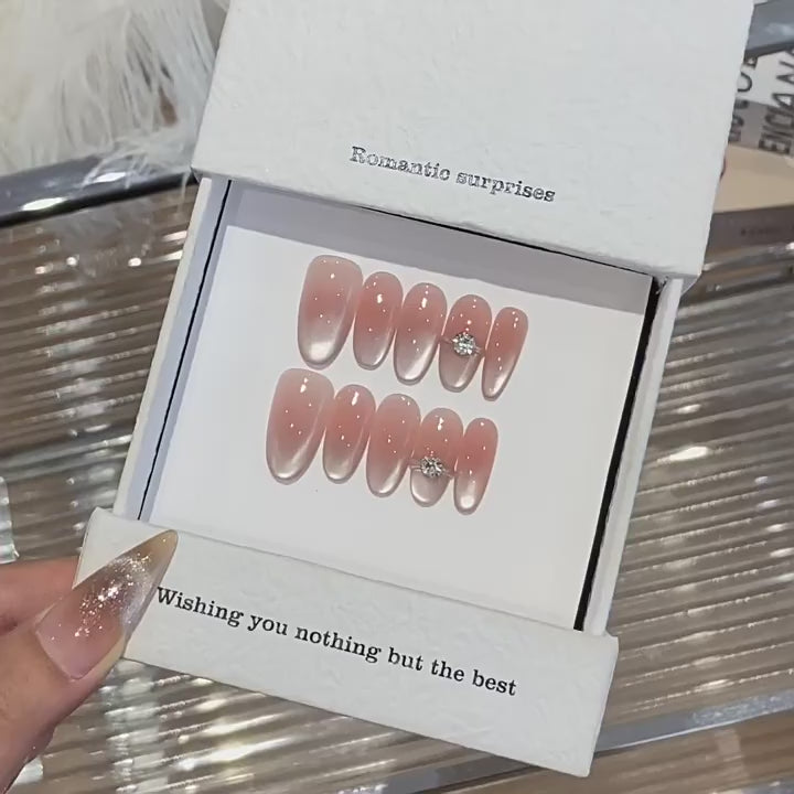 Blush Solitaire product video showing nude blush cat-eye press-on nails with silver tips and crystal accents