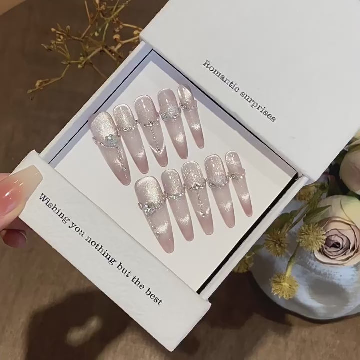 Moonlit Rosette product video showing champagne cat-eye press-on nails with chains and rose crystals