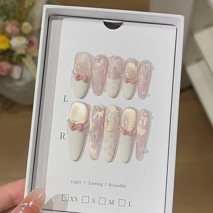 Ribbon Souffle product video showing blush French press-on nails with bows and champagne shimmer