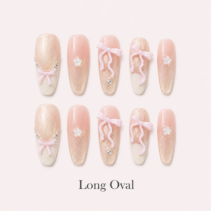 Ribbon Constellation Long Oval handmade press-on nails with blush shimmer, bows, stars and rhinestones