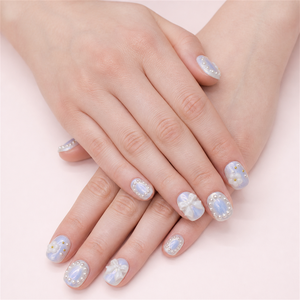 Ribbon Frost short square press-on nails in a two-hand soft-pose view.