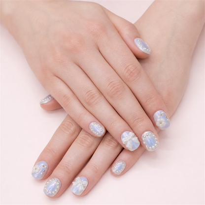 Ribbon Frost short square press-on nails in a two-hand soft-pose view.