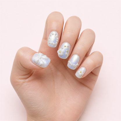 Ribbon Frost short square press-on nails in a single-hand relaxed view.