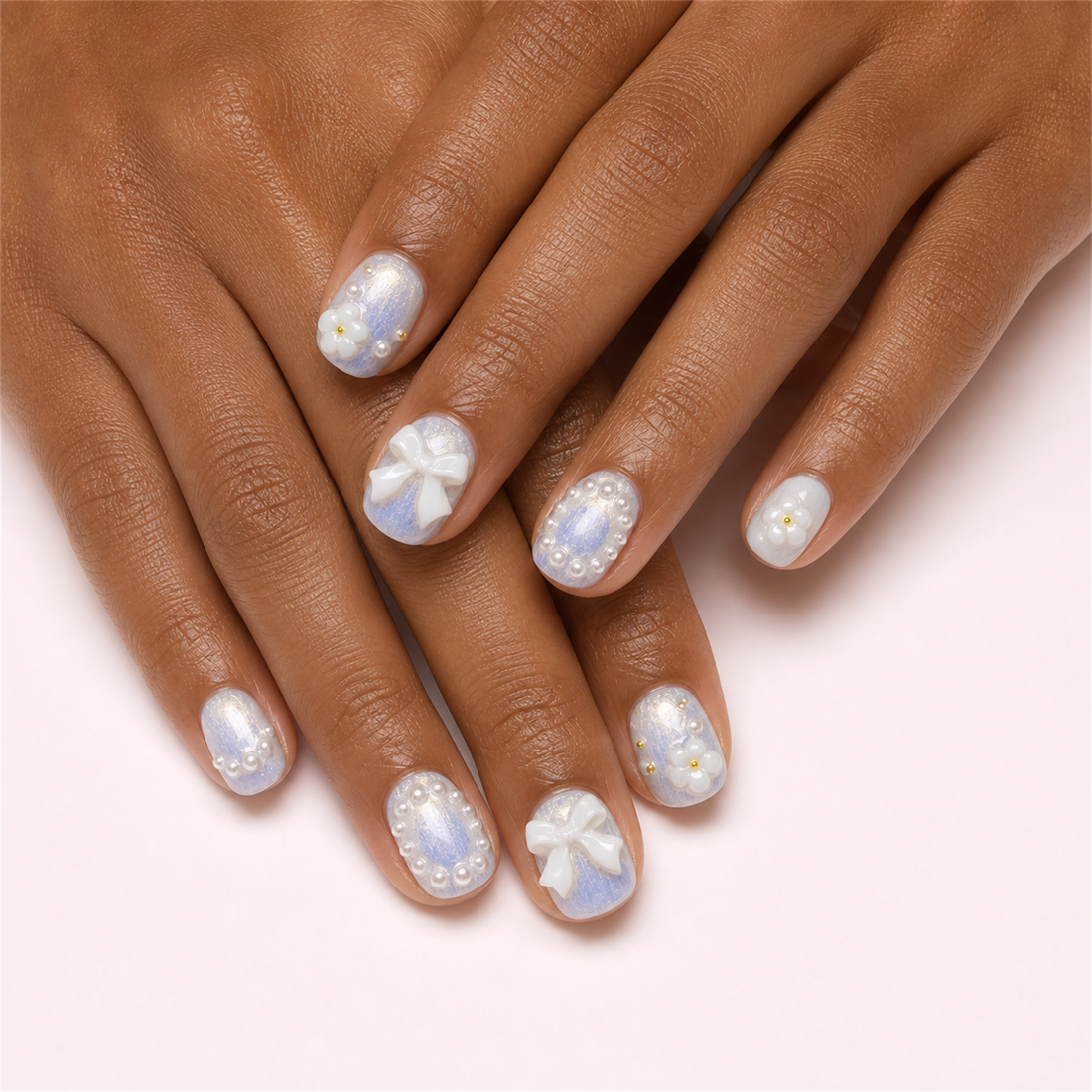 Ribbon Frost short square press-on nails in a two-hand lifestyle view.
