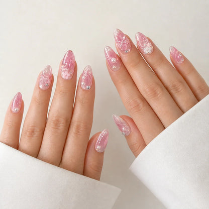 Roselight Terrarium pink floral medium almond press-on nails on two open hands
