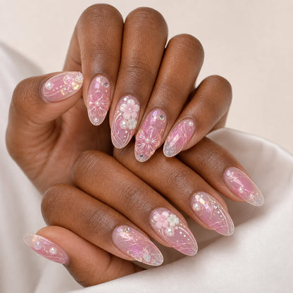 Roselight Terrarium pink floral medium almond press-on nails on two medium-brown hands