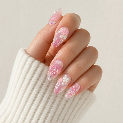 Roselight Terrarium pink floral medium almond press-on nails on one softly curled hand