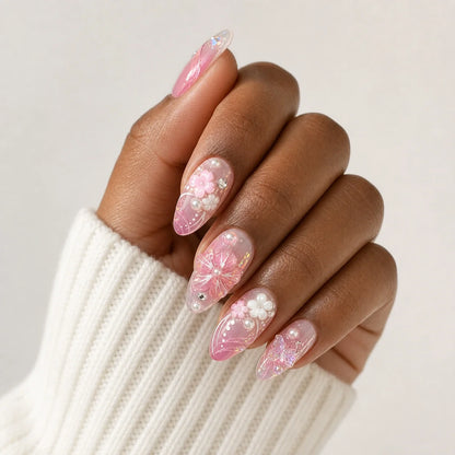 Roselight Terrarium pink floral medium almond press-on nails on one medium-brown hand