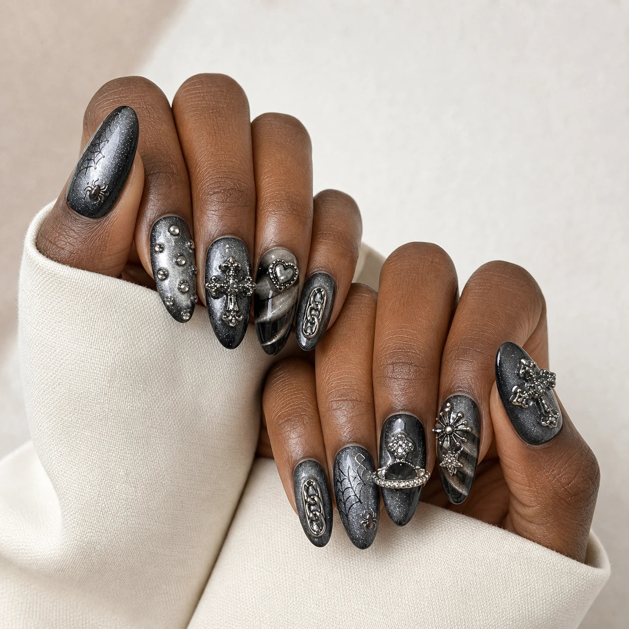 Silver Seance black silver manicure on two medium-brown hands