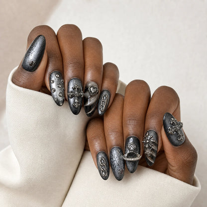 Silver Seance black silver manicure on two medium-brown hands