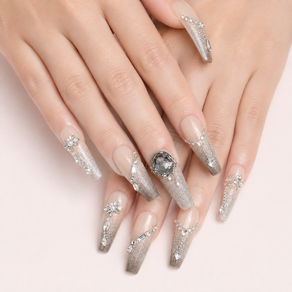 Two light-skin hands wearing Smoky Diadem long coffin press-on nails with silver glitter and crystal details