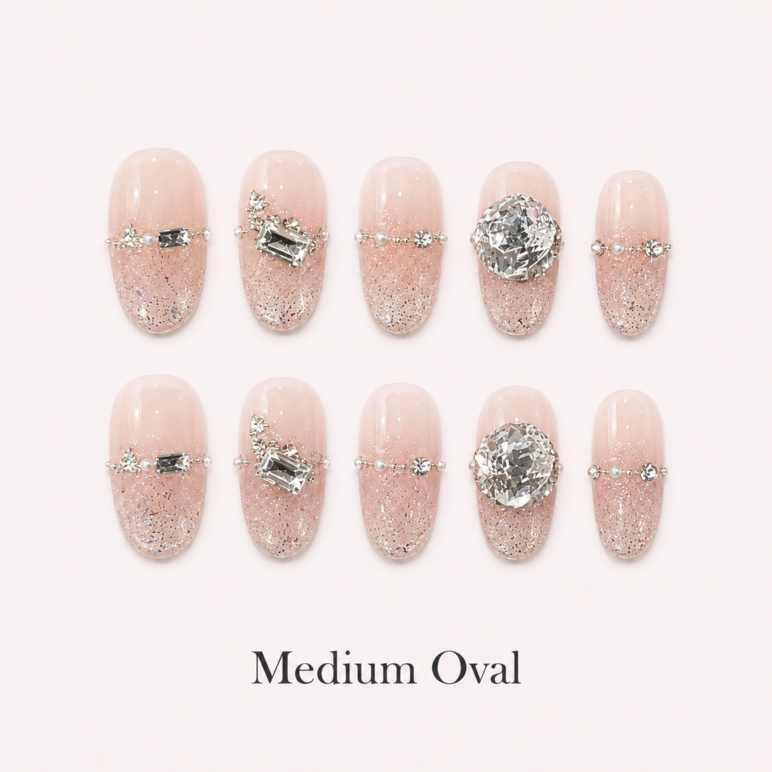 Starlit Blush Medium Oval handmade press-on nails with blush glitter and clear crystal accents