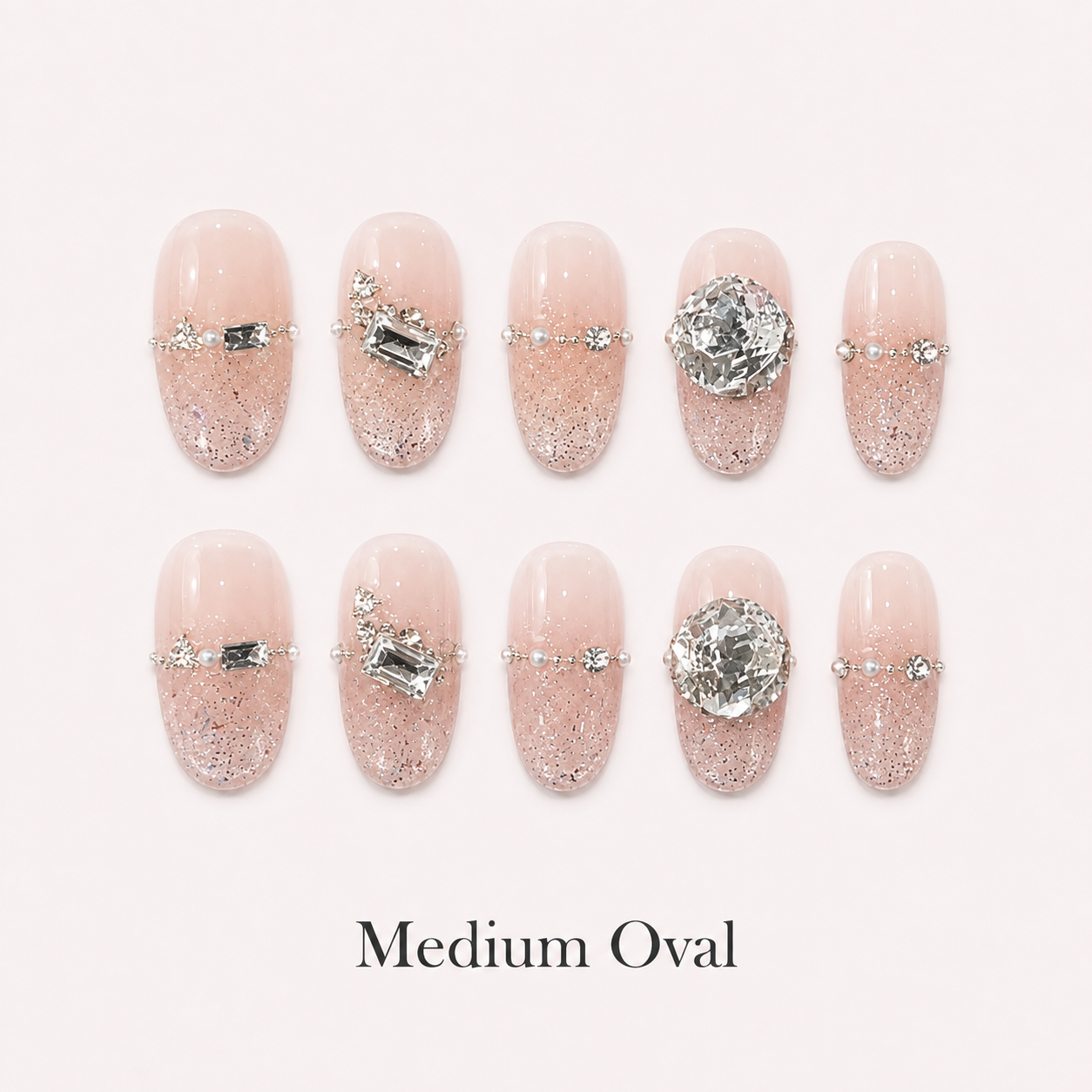 Starlit Blush Medium Oval handmade press-on nails with blush glitter and clear crystal accents