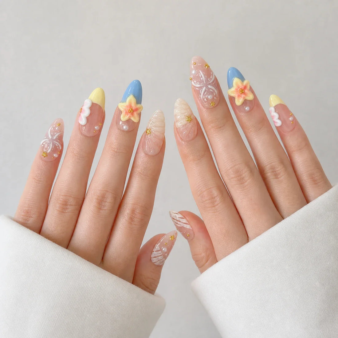 Sunlit Lagoon medium almond press-on nails on two open hands