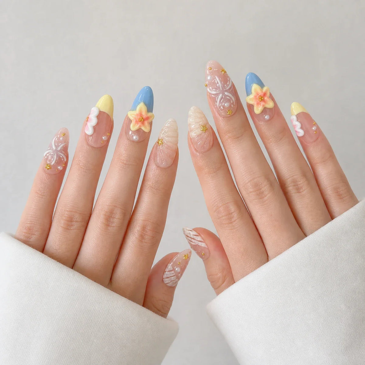 Sunlit Lagoon medium almond press-on nails on two open hands